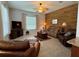 A living room features a wood accent wall, comfortable furniture, and a ceiling fan at 2515 Nw 53 Ave, Ocala, FL 34482