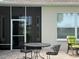Outdoor patio with brick flooring has a table and chairs, and a rocking chair to enjoy the weather at 2515 Nw 53 Ave, Ocala, FL 34482