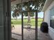 Exterior patio view through a screened door featuring seating, a grill, and a view of the golf course at 2515 Nw 53 Ave, Ocala, FL 34482