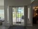 A view to the outside patio and golf course from a sliding glass door, featuring a brick patio, seating, and grill at 2515 Nw 53 Ave, Ocala, FL 34482