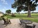 Outdoor seating area on brick paver patio looks out over the lush backyard at 2515 Nw 53 Ave, Ocala, FL 34482