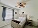 Bedroom featuring neutral decor, including a ceiling fan and window with curtains at 2515 Nw 53 Ave, Ocala, FL 34482