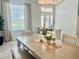 Bright dining area with decorative lighting, large windows, and comfortable seating for Gathering at 2515 Nw 53 Ave, Ocala, FL 34482