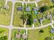 Bird's-eye view of homes with vibrant green yards, driveways and the nearby streets in a quiet neighborhood at 32 Dogwood Drive Loop, Ocala, FL 34472