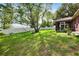 Expansive backyard with mature trees, a hammock, and a screened porch at 32 Dogwood Drive Loop, Ocala, FL 34472