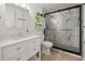 Modern bathroom with white vanity, toilet, and a glass-enclosed shower with marble-look tiling at 32 Dogwood Drive Loop, Ocala, FL 34472