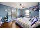 Relaxing bedroom features hardwood floors, blue walls, and a cozy hammock chair at 32 Dogwood Drive Loop, Ocala, FL 34472