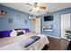 Cozy bedroom with hardwood floors, blue walls, ceiling fan, and comfortable furnishings at 32 Dogwood Drive Loop, Ocala, FL 34472