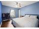 Bedroom with wood-look flooring and a light blue painted walls, ceiling fan, and a computer workstation at 32 Dogwood Drive Loop, Ocala, FL 34472