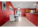 Charming dining room with red walls, tile flooring, and french doors leading to the outdoors at 32 Dogwood Drive Loop, Ocala, FL 34472
