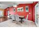 Charming dining room with tile flooring and walls painted in a vibrant red color, providing an inviting atmosphere at 32 Dogwood Drive Loop, Ocala, FL 34472