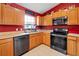 Well-lit kitchen features oak cabinets, stainless steel appliances, and sleek black dishwasher at 32 Dogwood Drive Loop, Ocala, FL 34472