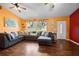 Stylish living room with hardwood floors, a comfortable sectional sofa, and lots of natural light at 32 Dogwood Drive Loop, Ocala, FL 34472