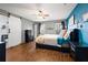 Cozy main bedroom featuring a modern barn door, hardwood floors, and neutral decor at 32 Dogwood Drive Loop, Ocala, FL 34472