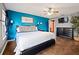 Spacious main bedroom with hardwood floors, a king-size bed, and a bright accent wall at 32 Dogwood Drive Loop, Ocala, FL 34472