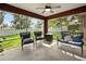 Relaxing screened patio with comfortable seating, ceiling fan and outdoor views at 32 Dogwood Drive Loop, Ocala, FL 34472