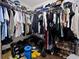 Large walk-in closet with abundant hanging storage and organization on shelving, and containing a variety of garments at 32 Dogwood Drive Loop, Ocala, FL 34472