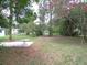 The spacious backyard features mature trees and lush greenery, perfect for outdoor entertaining and relaxation at 3418 Se 94Th St, Ocala, FL 34480