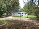 Spacious backyard features well-maintained landscaping and mature trees, creating a serene outdoor space at 3418 Se 94Th St, Ocala, FL 34480