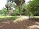 A sprawling backyard with mature trees provides ample shade and space for outdoor enjoyment at 3418 Se 94Th St, Ocala, FL 34480