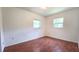 A bright bedroom with two windows offering natural light and wood-look flooring throughout at 3418 Se 94Th St, Ocala, FL 34480
