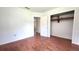 A spacious room with wood-look floors and a convenient closet space with built-in shelving at 3418 Se 94Th St, Ocala, FL 34480