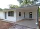 Attached carport area with gray support beams offers convenient covered parking and easy access to the house at 3418 Se 94Th St, Ocala, FL 34480