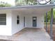 Covered carport area featuring fresh paint, sturdy support beams, and space for vehicles or outdoor seating at 3418 Se 94Th St, Ocala, FL 34480