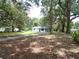 Quaint home with a long driveway, situated on a spacious lot with mature trees and a serene setting at 3418 Se 94Th St, Ocala, FL 34480