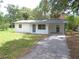 Classic home featuring a covered carport area, perfect for parking, with fresh exterior paint and trim at 3418 Se 94Th St, Ocala, FL 34480