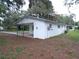 A cozy white home features a covered carport, offering convenient parking and protection from the elements at 3418 Se 94Th St, Ocala, FL 34480