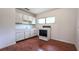 Compact kitchen features white cabinets, a stainless sink, and a matching white oven and cooktop at 3418 Se 94Th St, Ocala, FL 34480