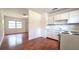 The kitchen features white cabinets and appliances, seamlessly connecting with an adjacent living area at 3418 Se 94Th St, Ocala, FL 34480