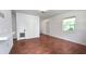 Living room features wood-look floors, a bright window, and multiple doors providing easy access at 3418 Se 94Th St, Ocala, FL 34480