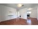 The open-concept living space features wood-look flooring and seamless transition to the adjacent kitchen with white appliances at 3418 Se 94Th St, Ocala, FL 34480
