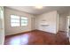 A bright and airy main bedroom with wood-look floors features a large window and neutral wall color at 3418 Se 94Th St, Ocala, FL 34480