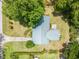Bird's eye view of a home with a metal roof, lush greenery, and mature trees at 3621 Se 12Th Pl, Ocala, FL 34471