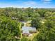 Charming house nestled among mature trees features lush landscaping, a well-maintained lawn and a welcoming driveway at 3621 Se 12Th Pl, Ocala, FL 34471