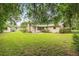 Green backyard with a storage shed and mature trees at 3621 Se 12Th Pl, Ocala, FL 34471