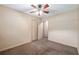 This bedroom includes neutral carpeting, a ceiling fan, and closet space at 3621 Se 12Th Pl, Ocala, FL 34471