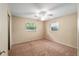This bedroom features neutral carpeting, two windows, and a ceiling fan at 3621 Se 12Th Pl, Ocala, FL 34471