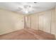 This bedroom offers neutral carpet, a ceiling fan, and closet space at 3621 Se 12Th Pl, Ocala, FL 34471