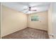 This is a compact bedroom with neutral carpeting and a ceiling fan at 3621 Se 12Th Pl, Ocala, FL 34471