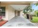 This is a view of the carport, featuring the side entry door and room for parking at 3621 Se 12Th Pl, Ocala, FL 34471