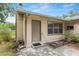 Rear view of the home showing door, windows, and patio at 3621 Se 12Th Pl, Ocala, FL 34471