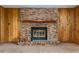 Close up on brick fireplace with wooden mantel and logs at 3621 Se 12Th Pl, Ocala, FL 34471
