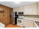 Traditional kitchen with stainless steel refrigerator, microwave, and white appliances at 3621 Se 12Th Pl, Ocala, FL 34471