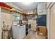 The laundry room has a washer and dryer, along with shelving for storage at 3621 Se 12Th Pl, Ocala, FL 34471