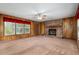 Living room with a brick fireplace and hearth, paneled walls, and large window at 3621 Se 12Th Pl, Ocala, FL 34471
