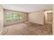 The living room features a window, a door, and access to the corridor that leads to other areas of the home at 3621 Se 12Th Pl, Ocala, FL 34471